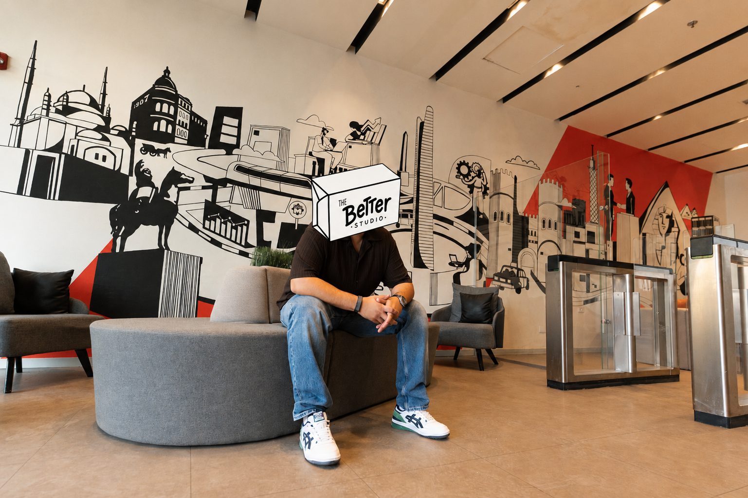 The Better Studio founder with the butter box in front of a line mural